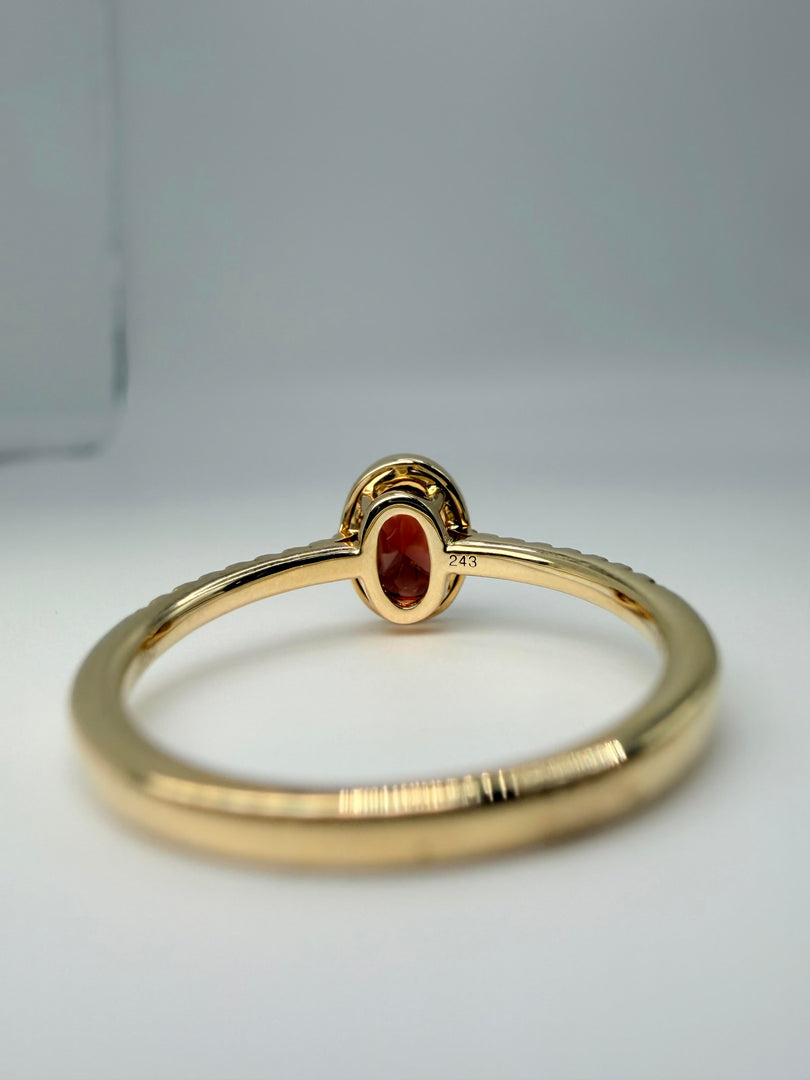 14Kt Yellow Gold .86Ct Oval Bezel Set Garnet Center With 1/10Tw Diamond On The Band (25330606)