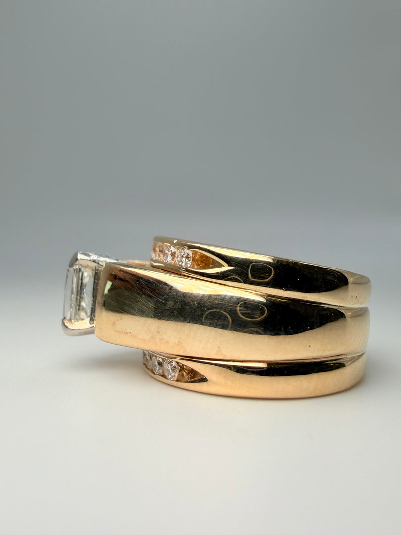 14Kt Yellow Gold Engagment Ring With 1.03 Radiant Diamond With A Color Of G And A Clarity Of Si2 Soldered Together Is 2 14Kt Yellow Gold Bands With 9 Round Diamonds On Each Ring.