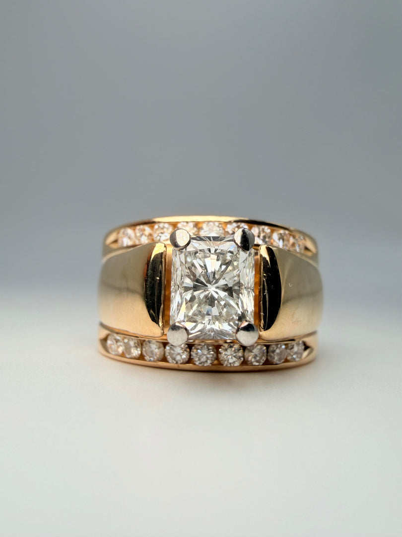 14Kt Yellow Gold Engagment Ring With 1.03 Radiant Diamond With A Color Of G And A Clarity Of Si2 Soldered Together Is 2 14Kt Yellow Gold Bands With 9 Round Diamonds On Each Ring.